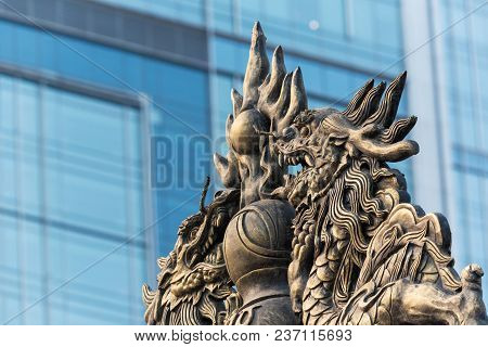 Dragon Sculpture On Daci Buddhist Temple Roof Against Modern Building In Chengdu, China
