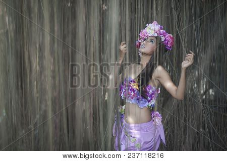 Young Asian Woman Tanned Skin And Black Shine Long Hair With Flowers Costume Design. Fancy Fairy Nym