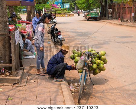 Siem Reap, Cambodia - 30 March, 2018: Coconut Seller On Bicycle. Simple Job Selling Coco Nuts. Stree