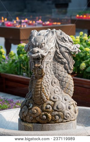 Dragon Sculpture In A Fountain In Daci Buddhist Temple Roof Against Modern Building In Chengdu, Chin