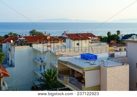 Nea Kallikratia, Greece - August 7, 2014: Top View Of Traditional Greek Low-rise Buildings On Backgr