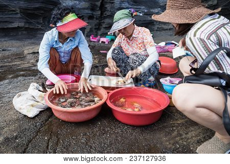 Yongmeori Beach, Sanbang-ro, Jeju Island, South Korea - August 28 2017: Local Women Selling Fresh Se