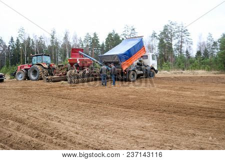 Sowing Unit, Combine Harvester, Seeder And Lorry, Dumper On The Field.