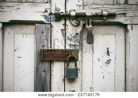The Old Aged White Wooden Door With Latch Locking With The Rustic Key Lock On The Hinge