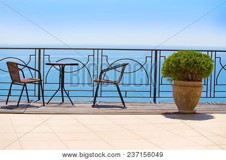 Chairs And Table On Protected Terassa By Sea