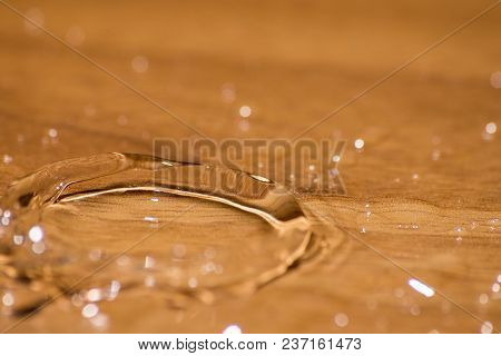 Shining Drop Of Water Colored Of Orange Isolated Composition