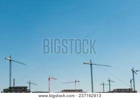 Brasov, Romania-21 April 2018: Huge Cranes At Building Site, Residentual Apartments,  With Blue Sky 