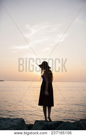 Beautiful Girl On A Sunset Background On A Sandy Beach. Woman.