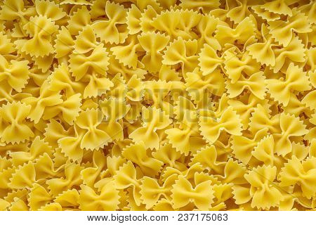 Farfalle Raw Farfallini Background With Pasta. A View From The Top, A Close-up Of A Texture.