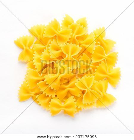 Farfalle Raw Farfallini Background With Pasta On White Isolated Background With Shadow. A View From 