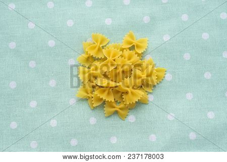 Farfalle Raw Farfallini A Handful Of Macaroni On A Rustic Green Textured Background To The Point. A 