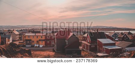 Norway. View Of Vardo City With Houses And Mountains With Snow, Even If It Is Summer, In The Back On
