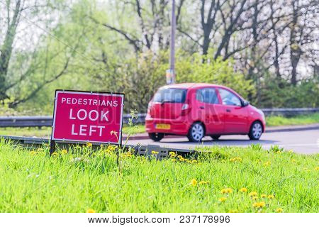 Pedestrians Look Left Roadworks Sign On Uk Motorway.