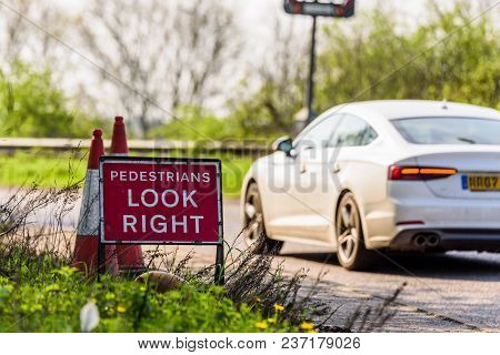 Pedestrians Look Right Roadworks Sign On Uk Motorway.