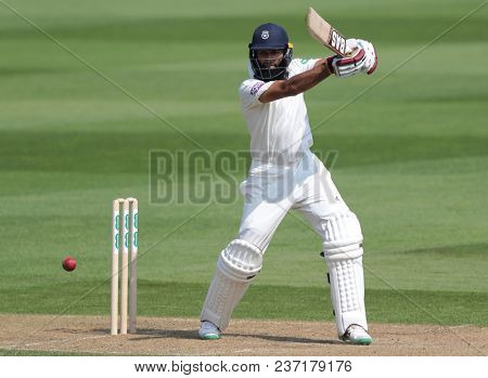 LONDON, ENGLAND - APRIL 21 2018: Hashim Amla of Hampshire hits the ball for four runs during Day Two of the Division One Specsavers County Championship match between Surrey and Hampshire