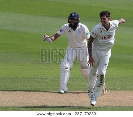 LONDON, ENGLAND - APRIL 21 2018: Hashim Amla of Hampshire and Jade Dernbach of Surrey during Day Two of the Division One Specsavers County Championship match between Surrey and Hampshire