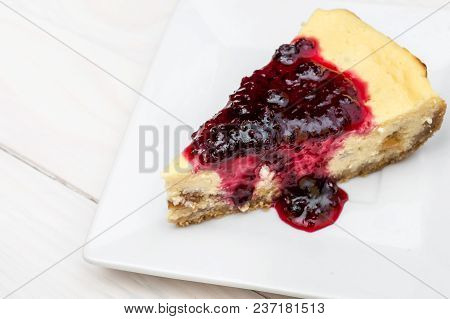 Piece Of Heesecake With Jam On Saucer. Top View.