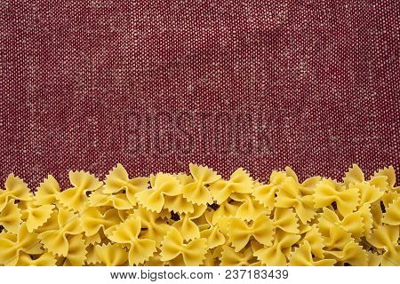 Farfalle Raw Farfallini Beautiful Decomposed Pasta From The Bottom On A Rustic Red-brown Textured Ba