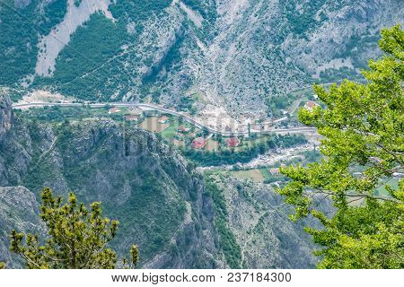 A Small Village Is At The Bottom Of A Deep Canyon