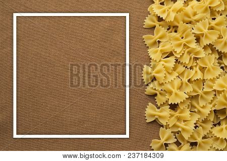 Farfalle Raw Farfallini Beautiful Decomposed Pasta With The Right, On Its Side On A Rustic Brown Tex