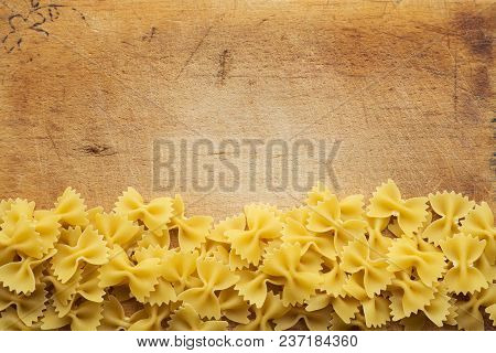 Farfalle Raw Farfallini Beautiful Decomposed Pasta With A Bottom On A Wooden Plank Texture Backgroun