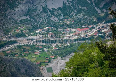 A Small Village Is At The Bottom Of A Deep Canyon