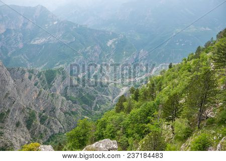 A Small Village Is At The Bottom Of A Deep Canyon
