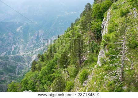 A Small Village Is At The Bottom Of A Deep Canyon