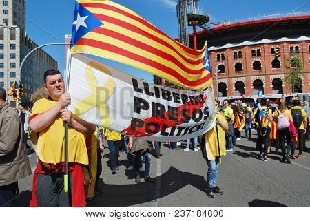 BARCELONA, SPAIN - APRIL 15, 2018: Catalans take part in the Llibertat Presos Politics (free political prisoners) protest march at Placa Espanya in support of jailed Catalan politicians.