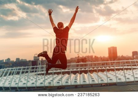 Silhouette Of A Person In A Jump. The Concept Of Victory, Achievement, Freedom.