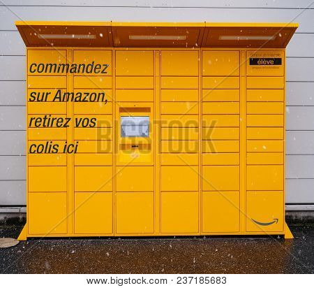 Lyon, France - Feb 4, 2017: Snowing In Front View Of Amazon Locker Orange Delivery Parcel Package Lo