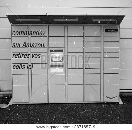 Lyon, France - Feb 4, 2017: Snowing In Front Of Modern Amazon Locker Orange Delivery Parcel Package 