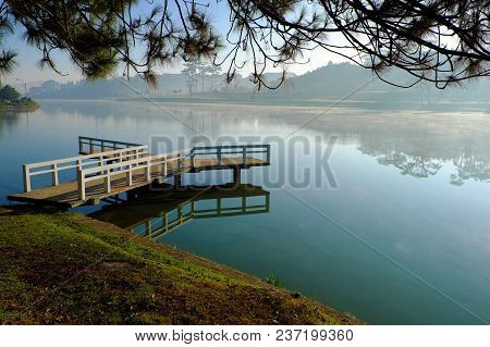 Destination For Vietnam Travel At Da Lat City, Mist Evaporate From Surface Water Of Lake, Silhouette