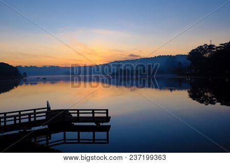 Destination For Vietnam Travel At Da Lat City, Mist Evaporate From Surface Water Of Lake, Silhouette