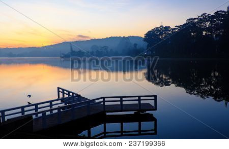 Destination For Vietnam Travel At Da Lat City, Mist Evaporate From Surface Water Of Lake, Silhouette