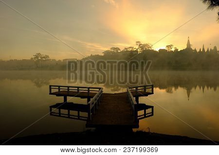 Destination For Vietnam Travel At Da Lat City, Mist Evaporate From Surface Water Of Lake, Silhouette