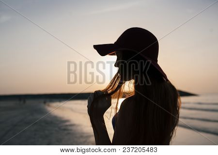 Beautiful Girl On A Sunset Background On A Sandy Beach. Woman.