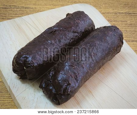 Japanese Cuisine, Traditional Unsliced Japanese Rice Maki Sushi Roll With Nori Seaweed On Cutting Bo
