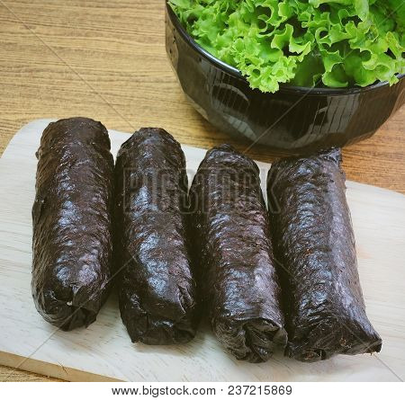 Japanese Cuisine, Traditional Unsliced Japanese Rice Maki Sushi Roll With Nori Seaweed On Cutting Bo