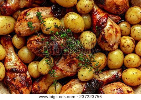 Oven Baked Chicken Drumsticks And New Baby Potatoes With Thyme In Pan, Ready To Serve.