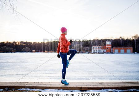 Potrtait Of Young Athlete Blonde At Morning Exercises In Winter Park