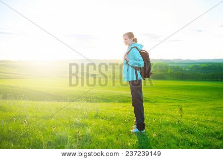 Young Woman Hiking In Beautiful Nature. Sports And Healthy Lifestyle Concept.