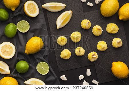 Slate Platters With Assortment Of Lemons And Limes On Black Background, Copy Space. Top View On Ripe