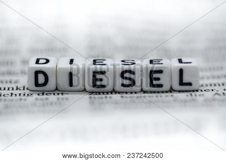 Word Diesel Formed By Wood Alphabet Blocks On Newspaper Closeup