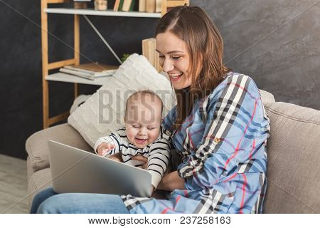 Beautiful Business Mom Working On Laptop In Office While Spending Time With Her Cute Baby. Business,