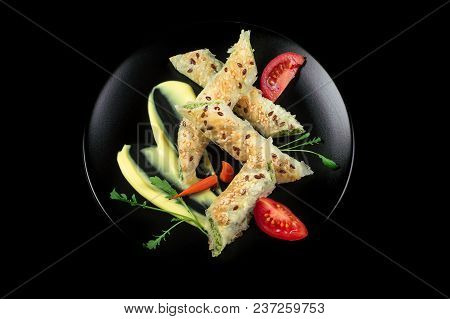Puff Pastry With Spinach And Cheese Filling On A Black Plate And Black Background.