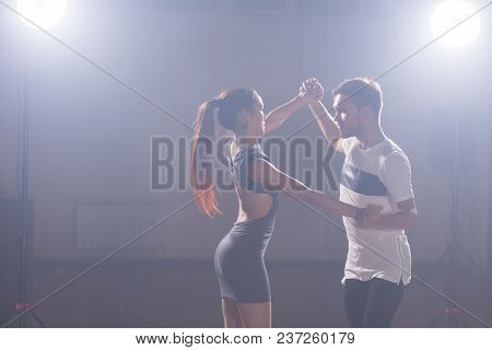 Young Couple Dancing Social Danse Kizomba Or Bachata Or Semba Or Taraxia In Dancing Class Background