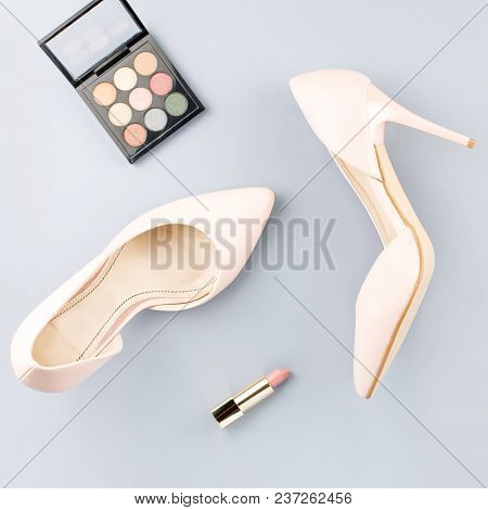 Pale Pink Female Shoes, Lipstick And Eyeshadow Palette On Grey Background. Fashion Blogger Concept F