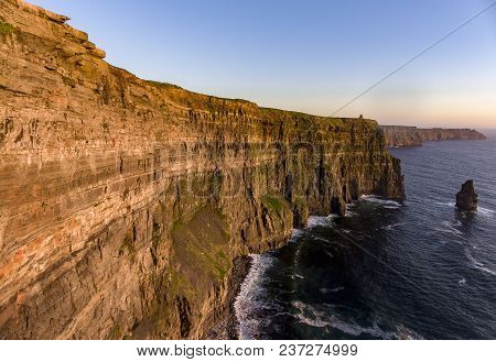 Beautiful Scenic Aerial Drone View Of Ireland Cliffs Of Moher In County Clare. Sunset Over The Cliff