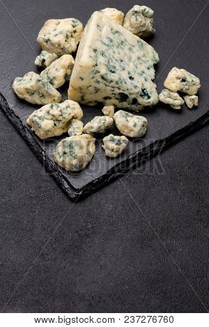 Slice Of French Roquefort Cheese On Stone Serving Board